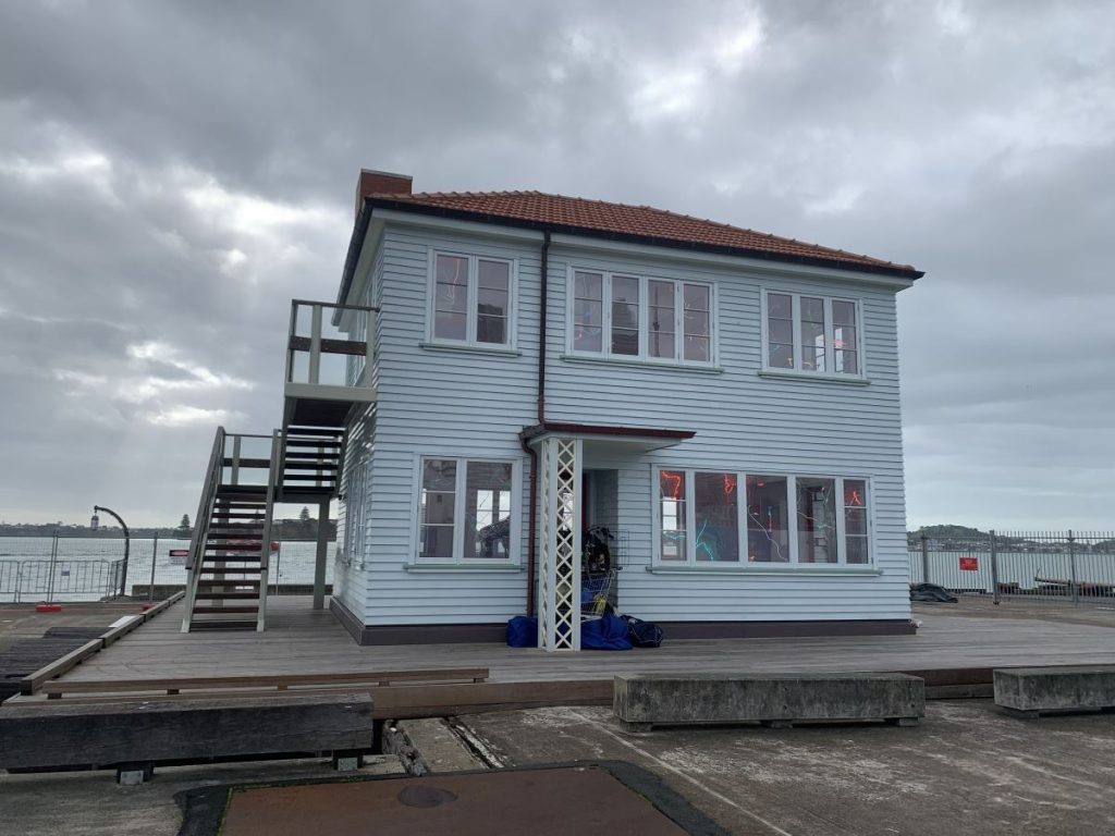 Exterior of the Lighthouse artwork in Auckland showing what looks like a simple 1950s weatherboard covered NZ home