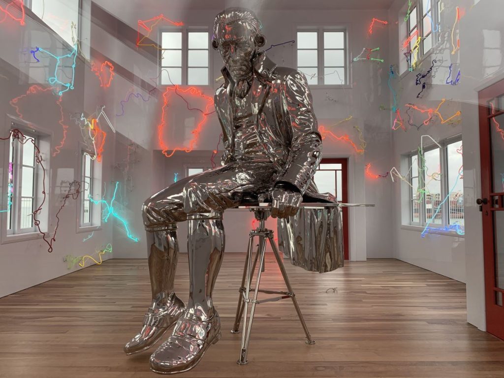 Silver statue of Captain Cook sittingo a chair surrounded by neon lights in Auckland