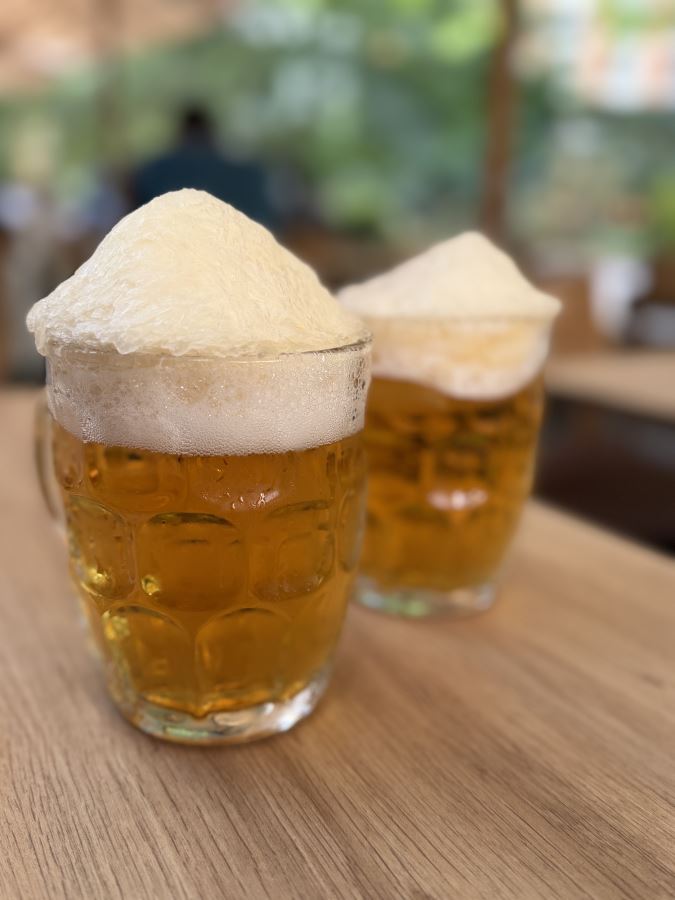 Two pints of beer with ice on the top from Kimchee in Kings Cross, London.