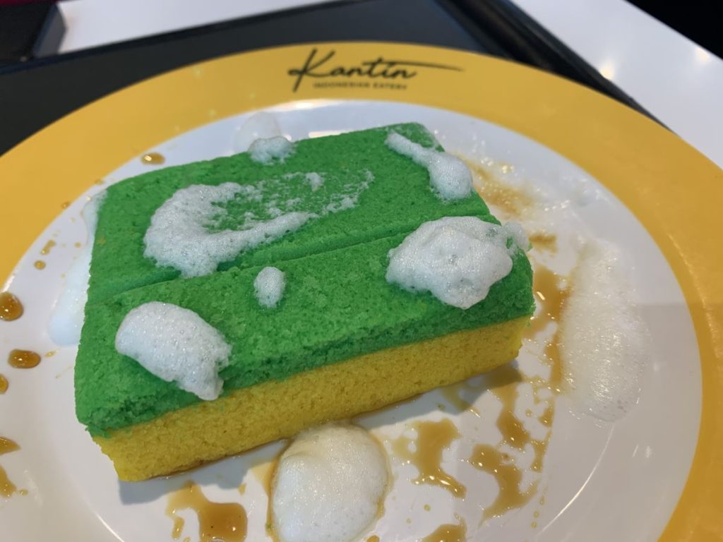 Yellow and green cake that looks like a classic sponge scourer on a yellow rimmed plate from Kantin