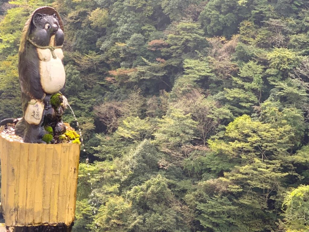 Tanuki statue balanced on the edge of a gorge in the Iya Valley - it is peeing into the gorge! 