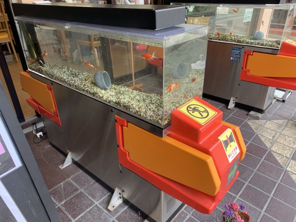 Old ticket barriers with goldfish tanks on top at the Goldfish Town near Nara, Japan