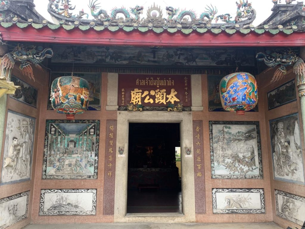 Carvings and paintings on the walls of a hidden rooftop temple in Bangkok