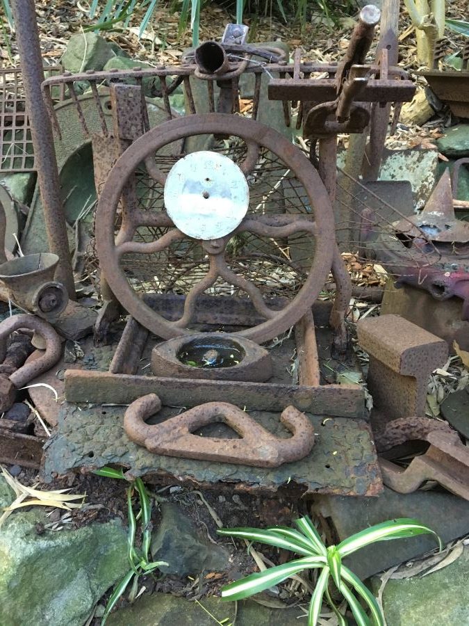 Old steering sheels nd other metal objects make up part of the decoration at Wendy Whiteley's Secret Garden