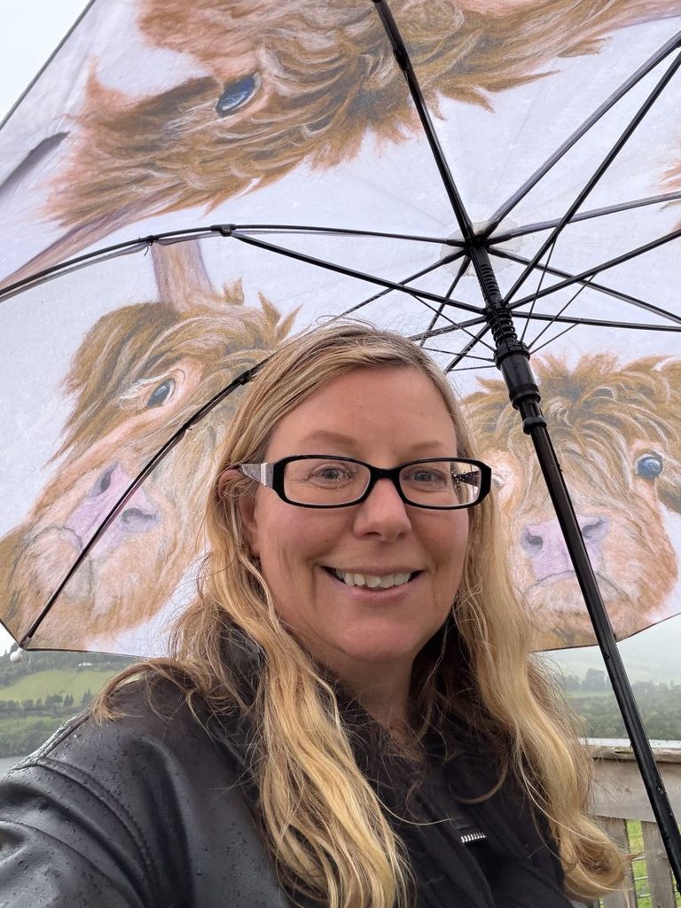 Helen from Differentville with a cute Highland Cow printed umbrella