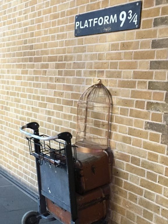 Luggage trolley and owl cage go through the wall into Platform 93/4 at Kings Cross Station